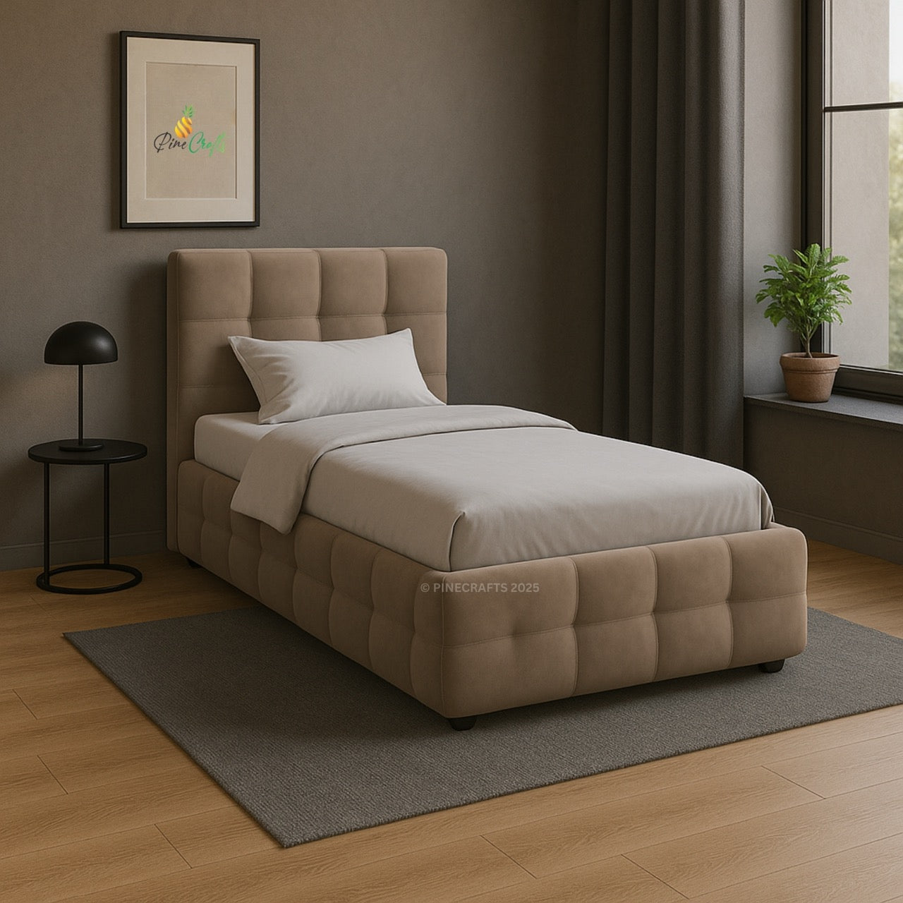 Beige upholstered bed in a room with a lamp, plant, and framed picture on the wall.