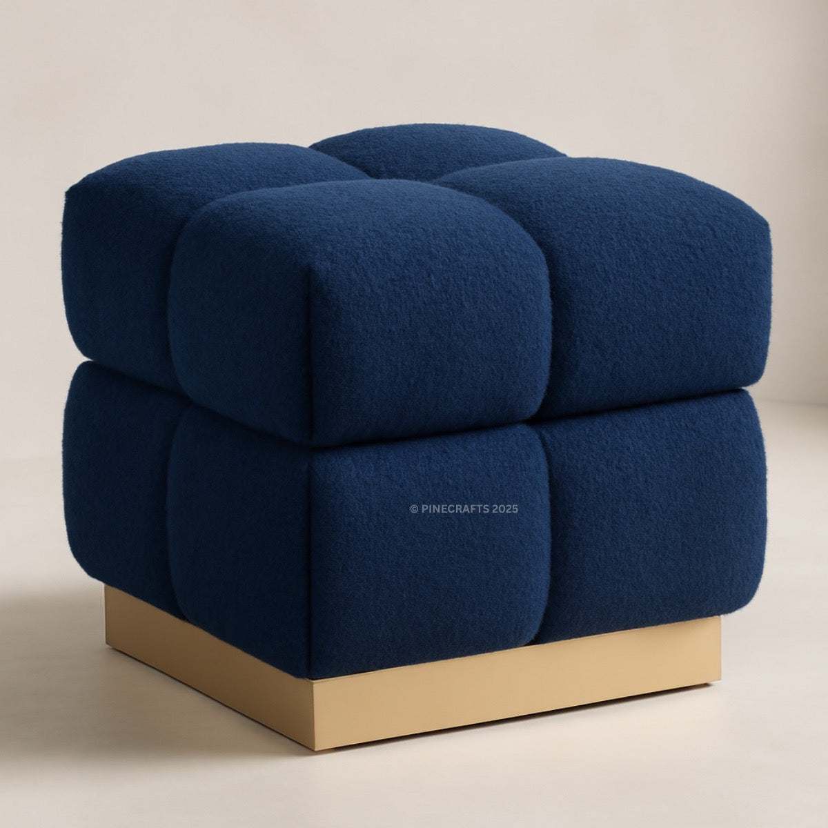 Blue cube-shaped chair with a gold base on a beige background