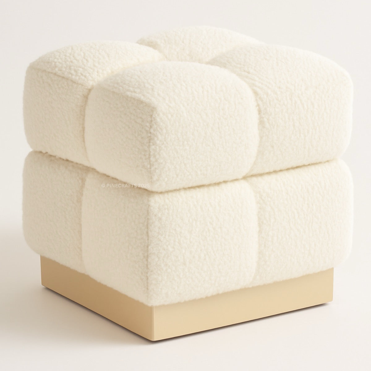 Cream-colored upholstered ottoman with a beige base on a light background