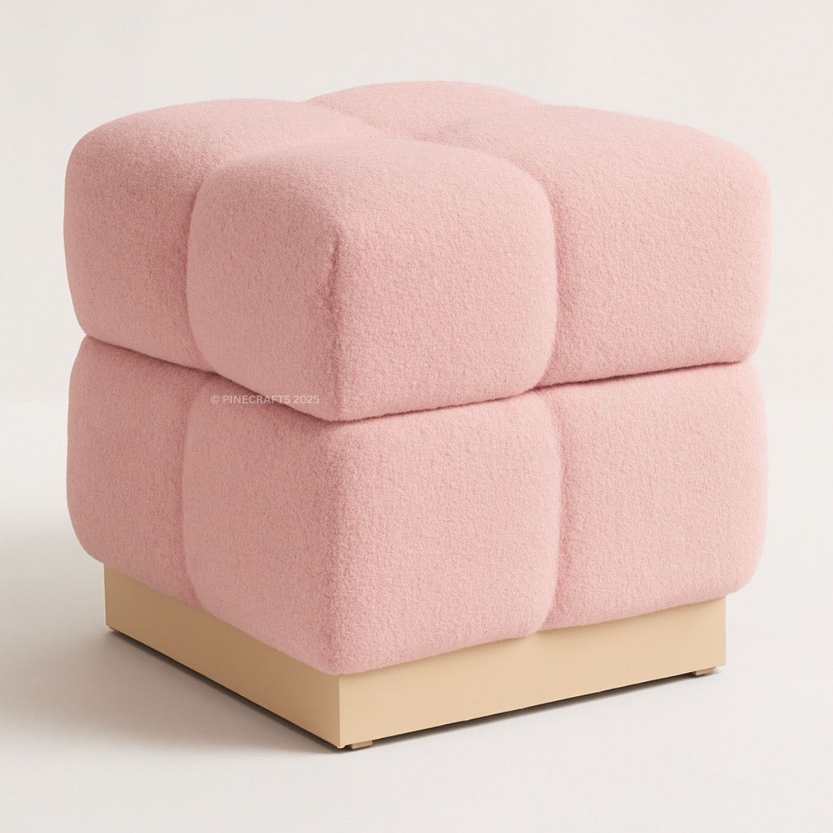 Pink cube-shaped ottoman on a light beige background