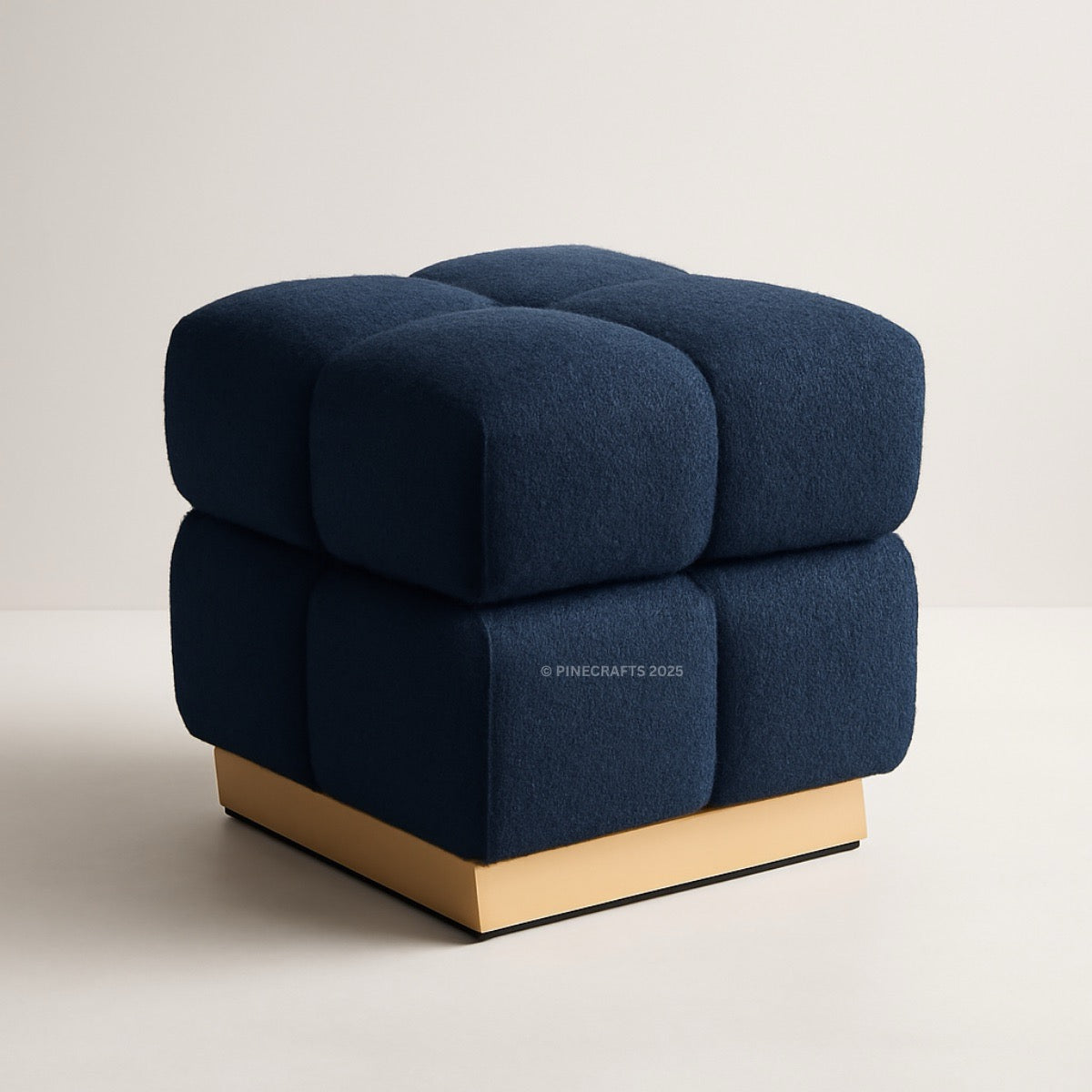 Blue cube-shaped chair with gold base on a beige background