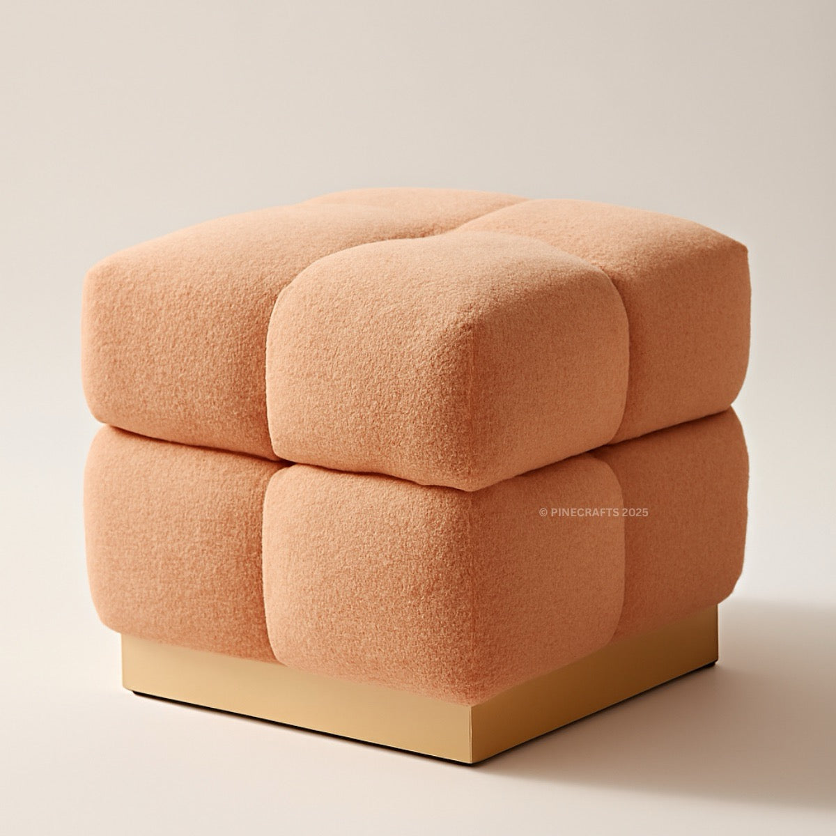 Square ottoman with a textured peach-colored surface on a beige background