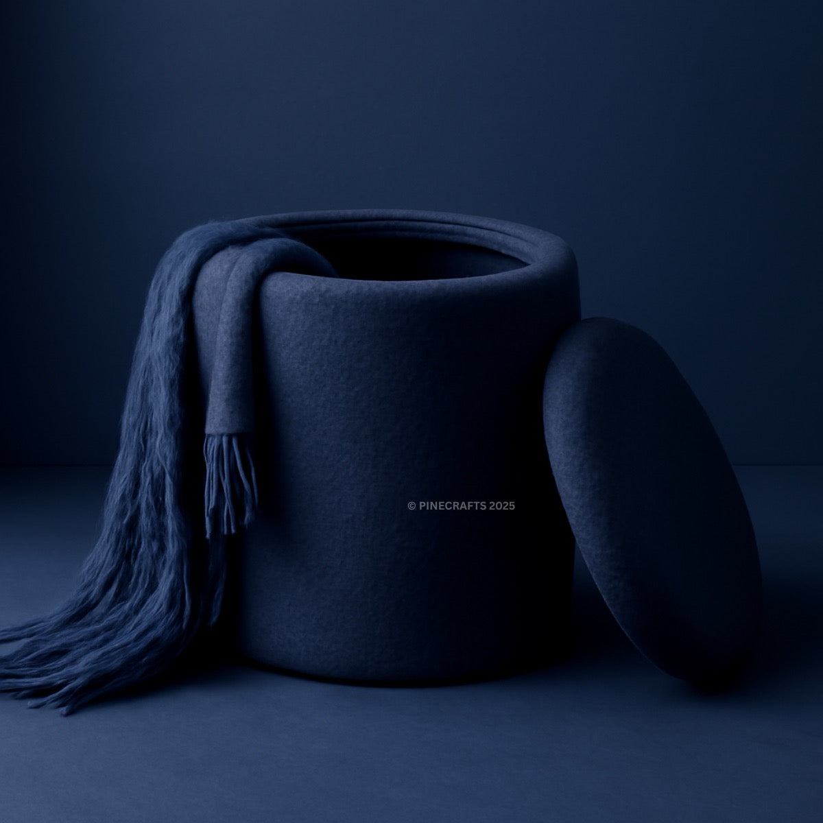 Dark blue textured container with a matching scarf draped over it on a dark background
