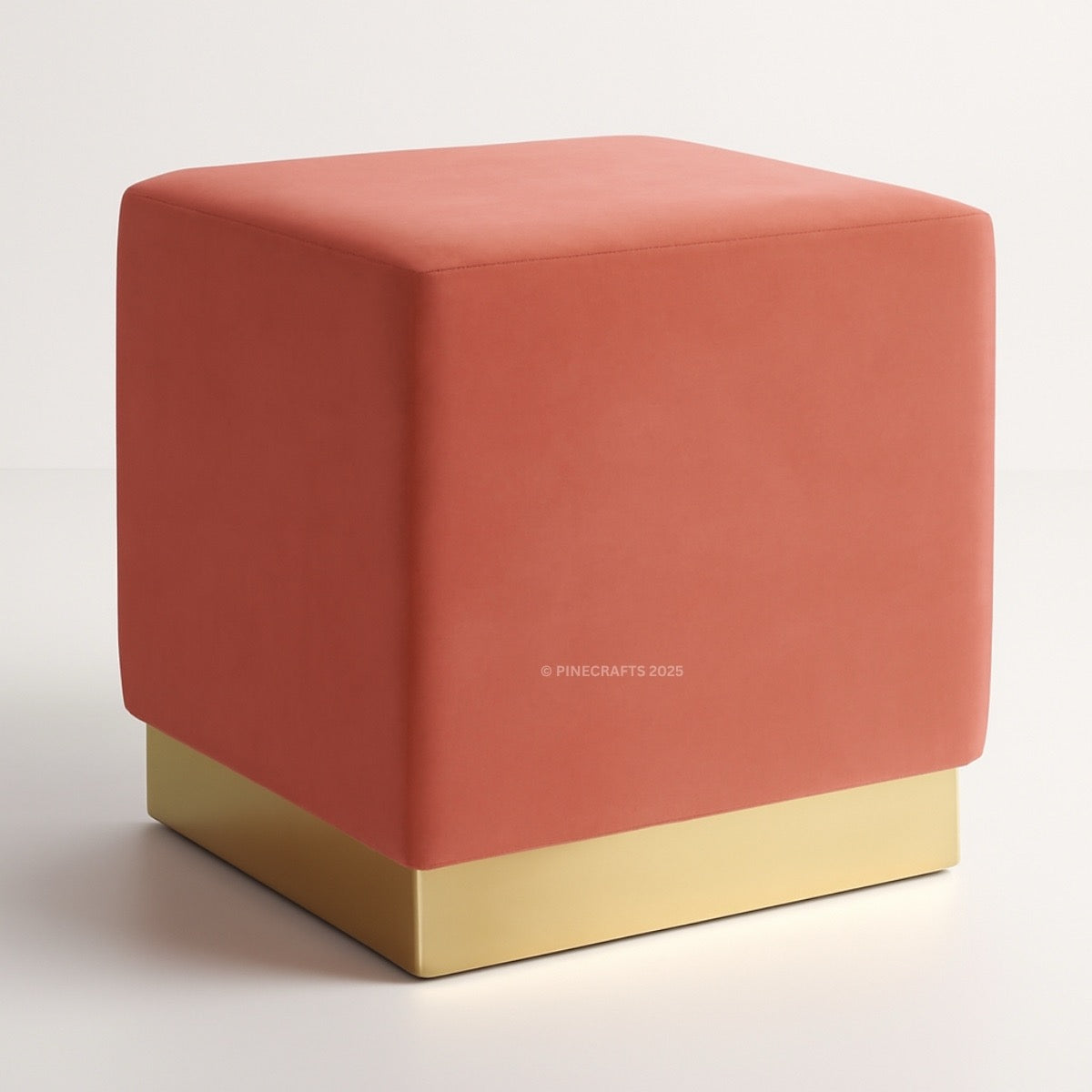 Coral cube ottoman with gold base on a white background