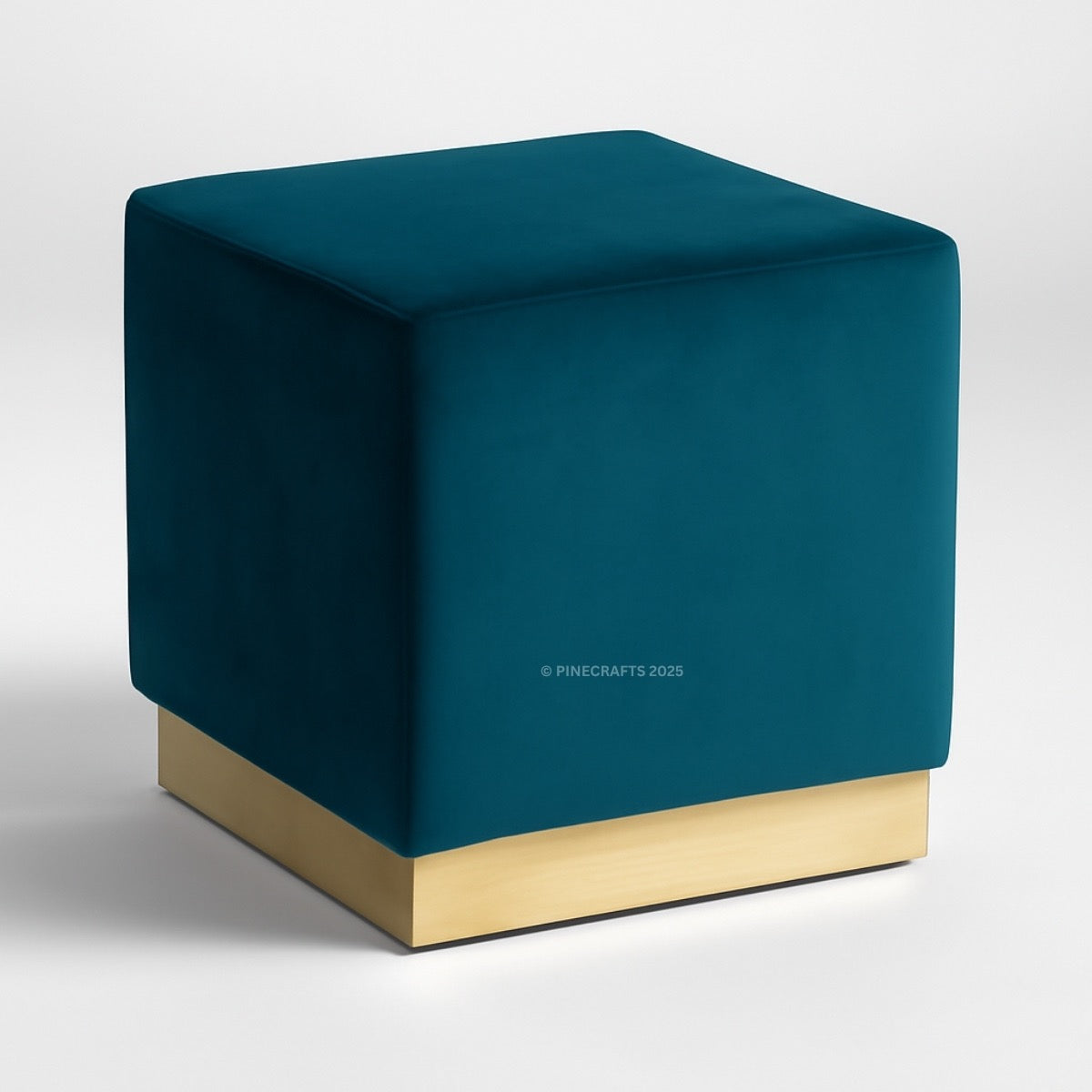 Teal cube-shaped ottoman with a gold base on a white background