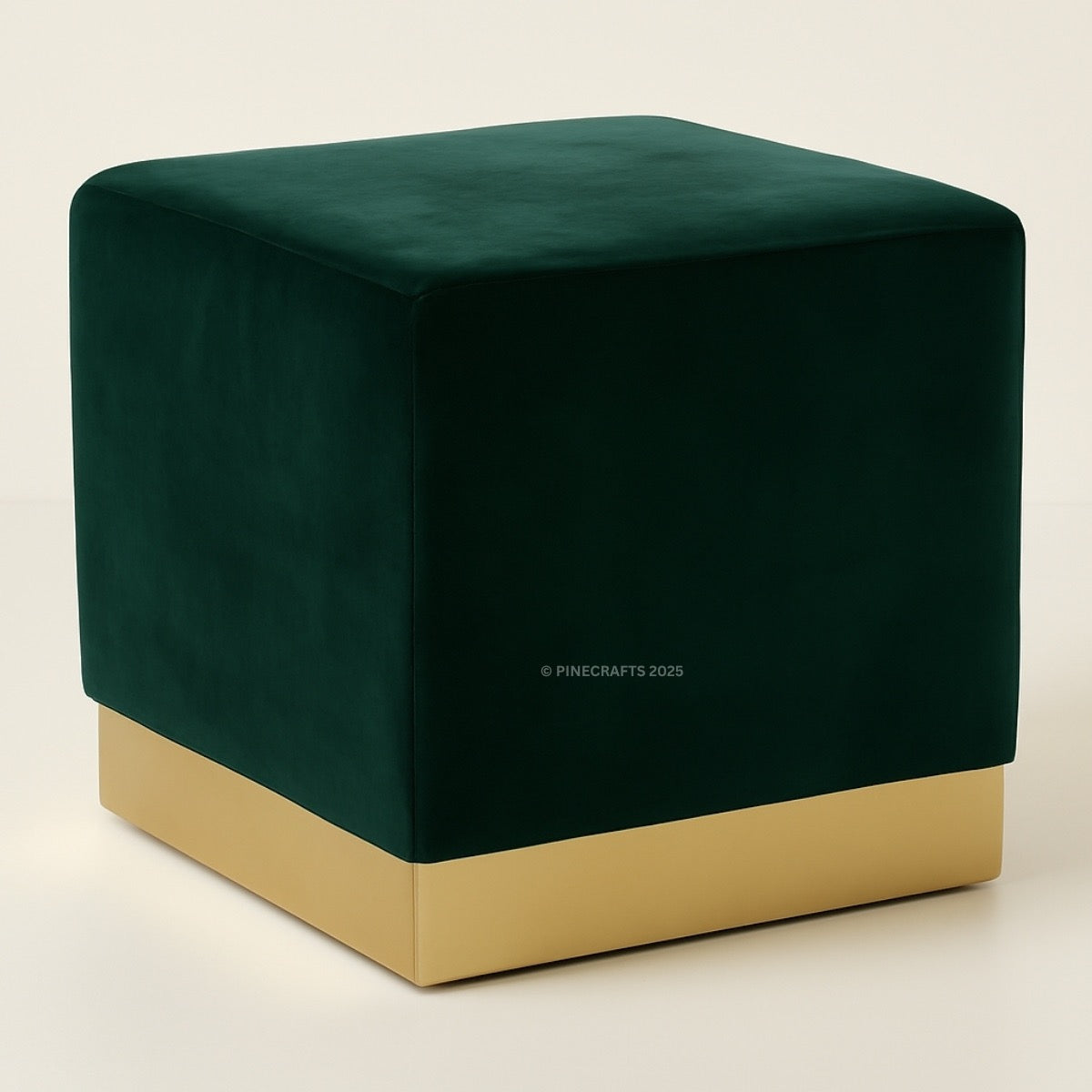 Green cube-shaped ottoman with gold base on a beige background