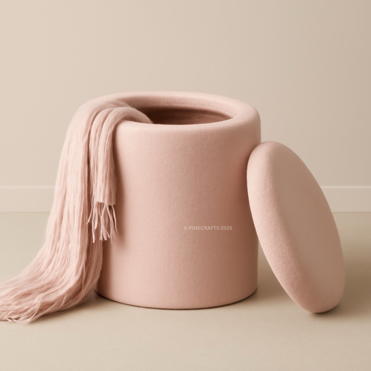 Pink storage jar with a matching lid and pink scarf on a beige background