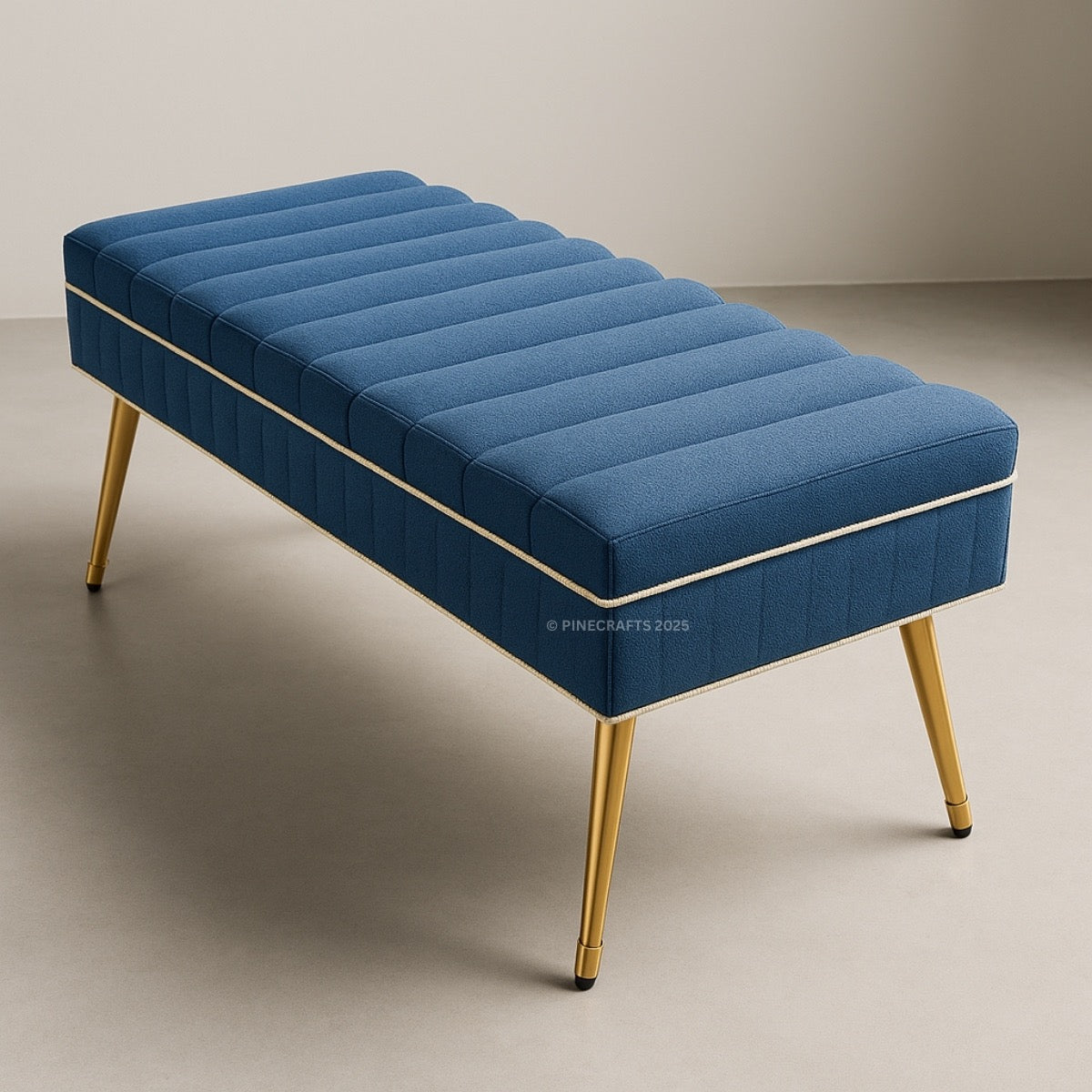 Blue tufted bench with gold legs on a neutral background