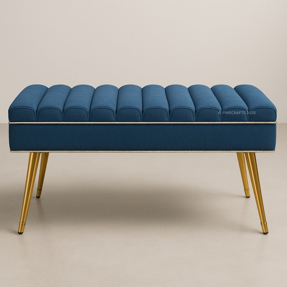 Blue tufted bench with gold legs on a beige background