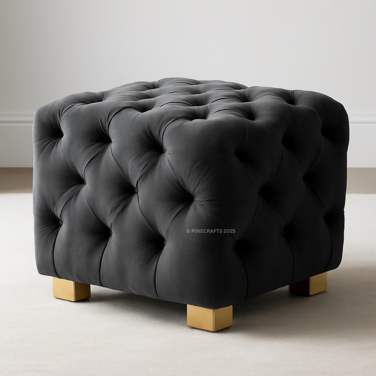 Black tufted ottoman with wooden legs on a neutral background