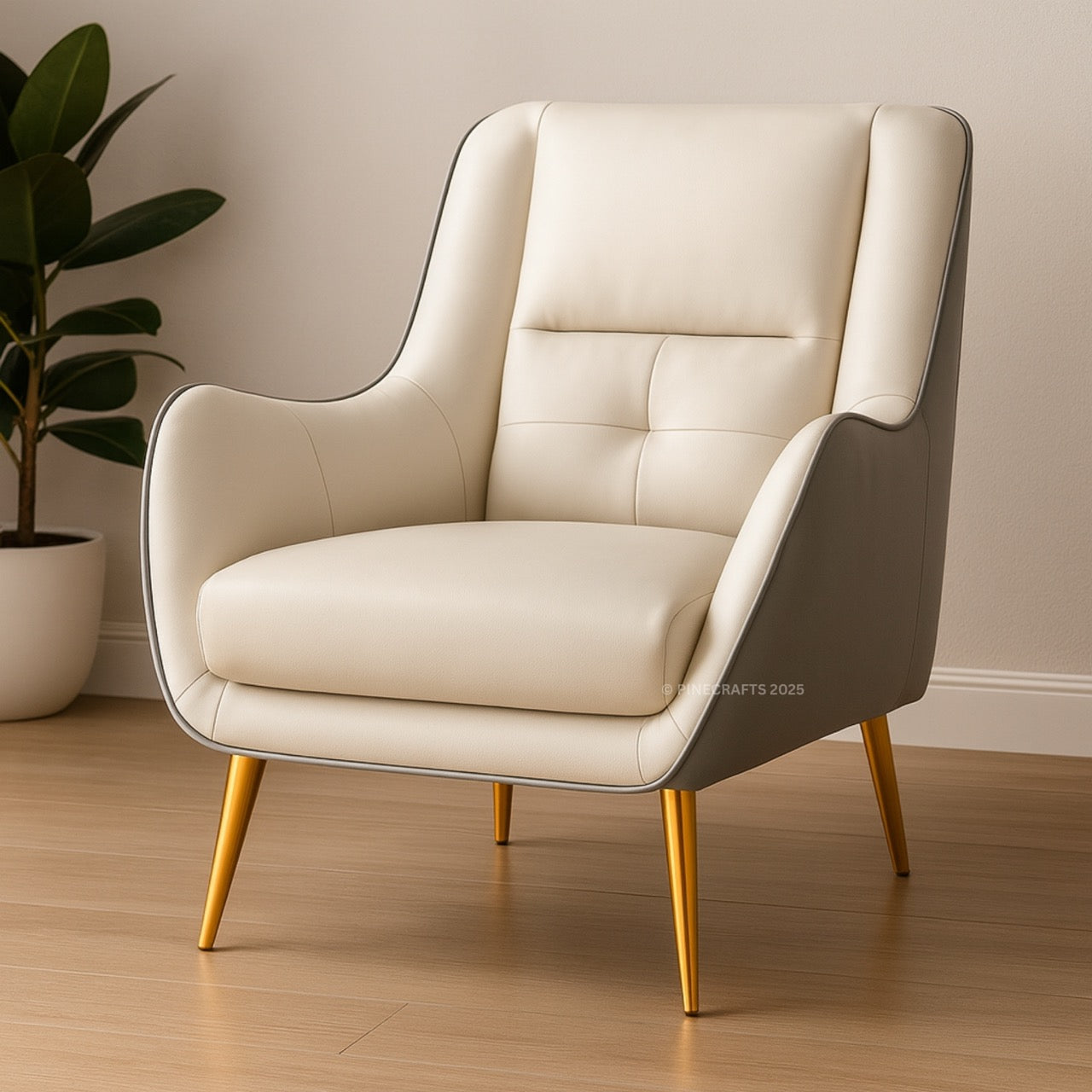 Beige armchair with gold legs in a room with a plant and neutral wall.