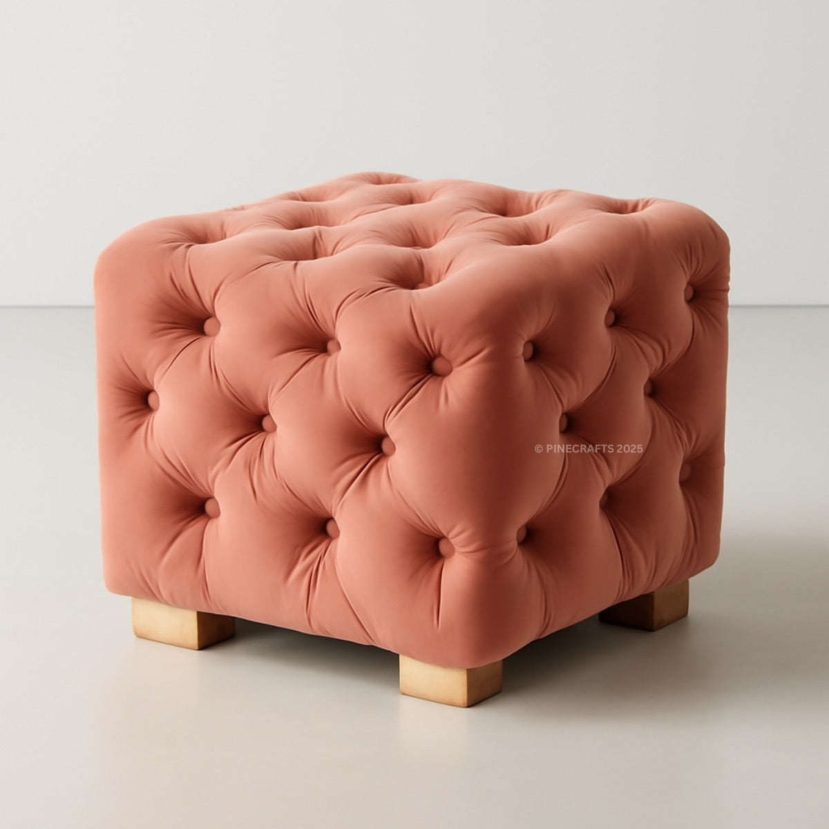 Pink tufted ottoman on a light gray background