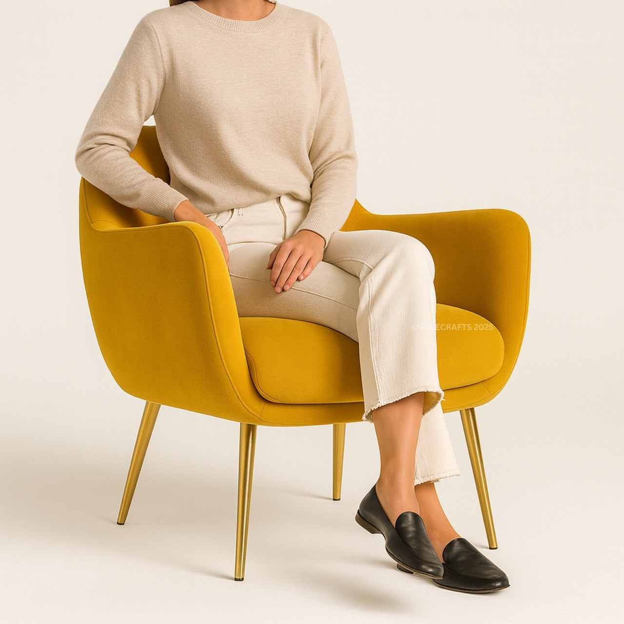 Person sitting on a mustard yellow chair with a plain background