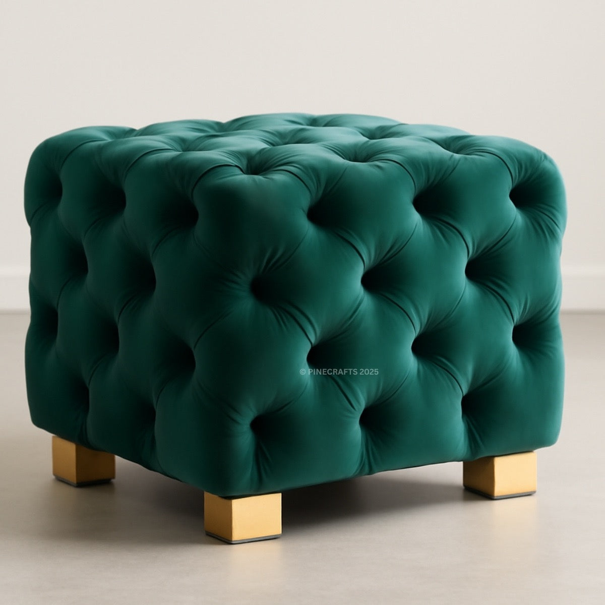 Green tufted ottoman with gold legs on a neutral background