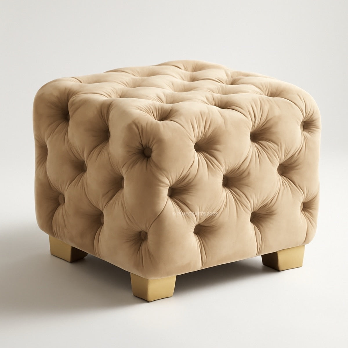 Beige tufted ottoman with gold legs on a light gray background