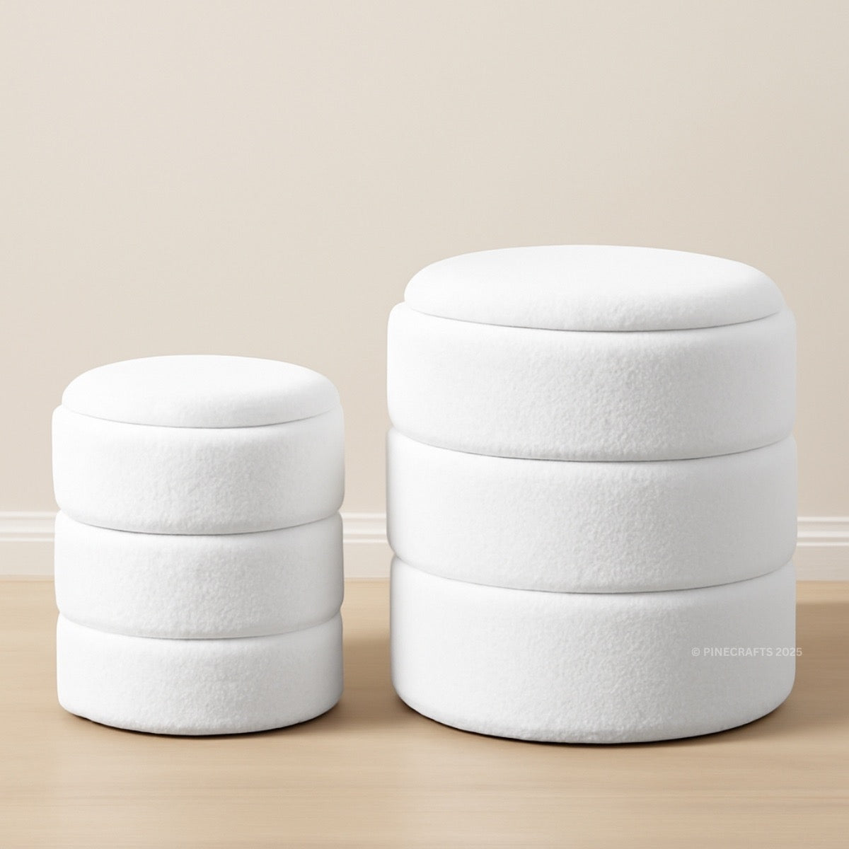 Two white round ottomans stacked on a beige floor with a neutral wall background.