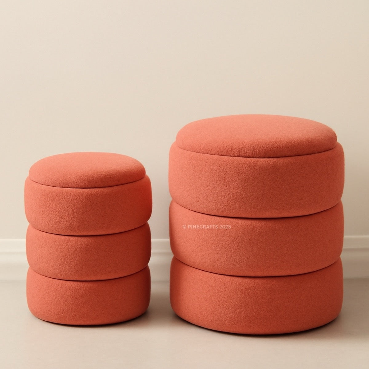 Two terracotta-colored ottomans stacked on a beige background