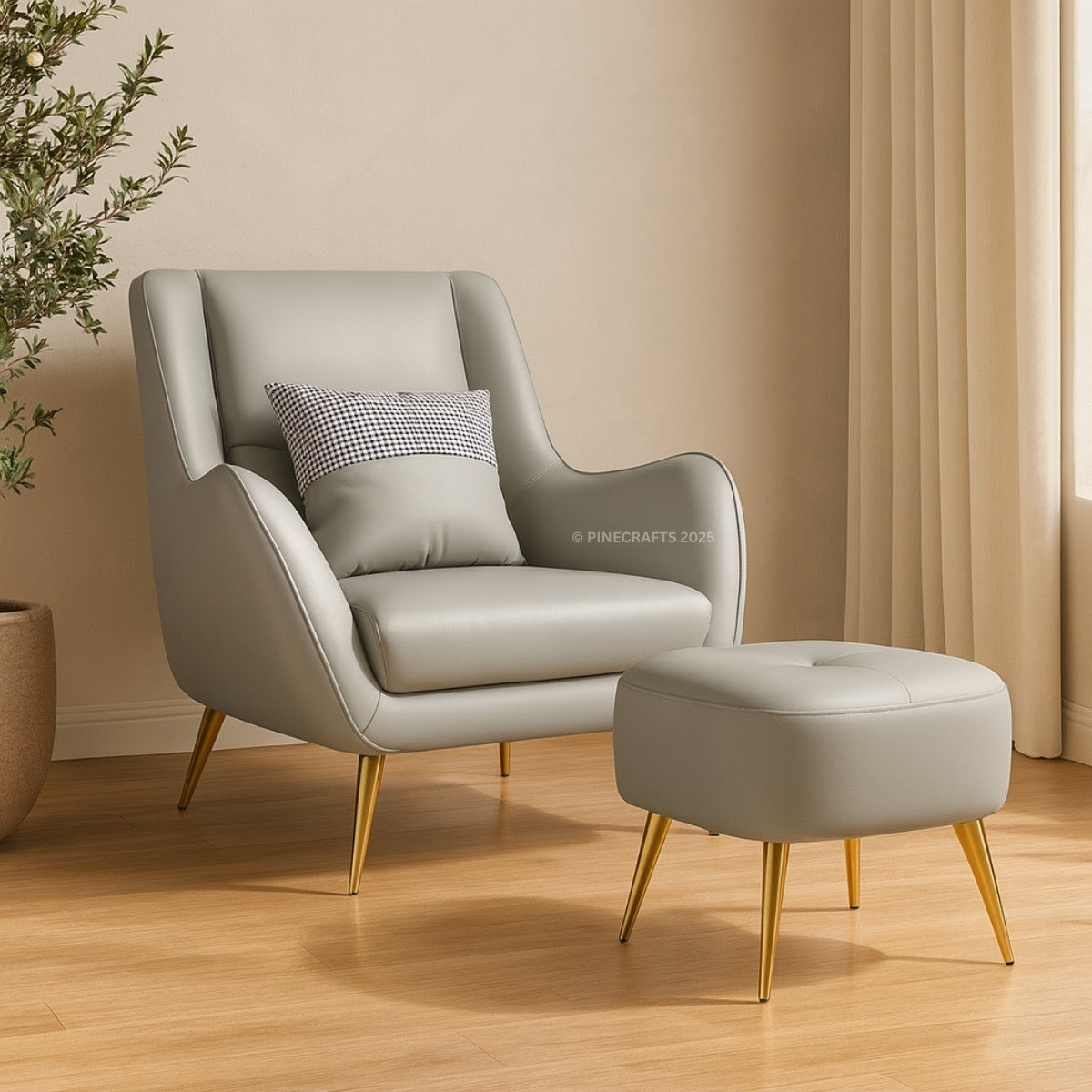 Gray armchair with a matching ottoman on a wooden floor, with a plant and curtain in the background.