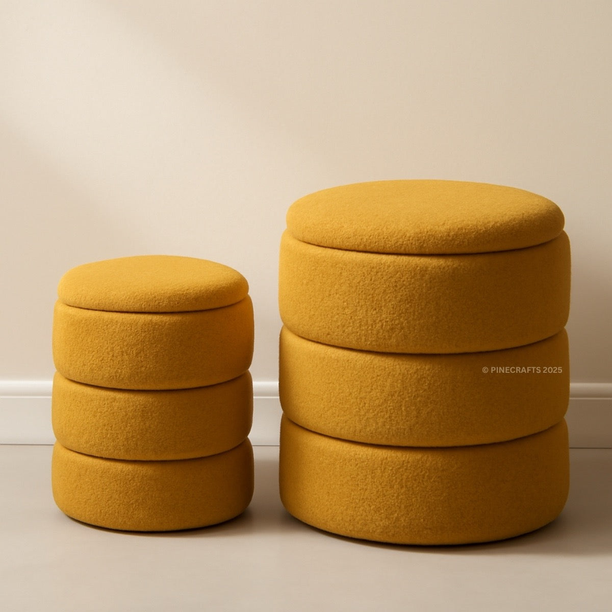 Two mustard yellow ottomans stacked on a beige floor with a plain wall background.