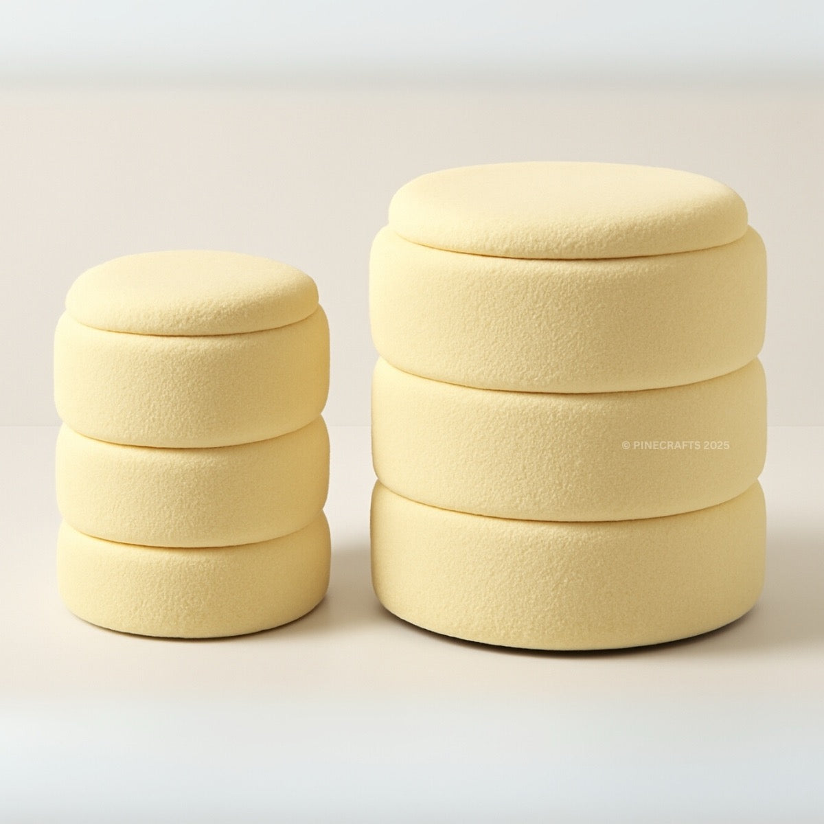 Two beige fabric ottomans stacked on a light background