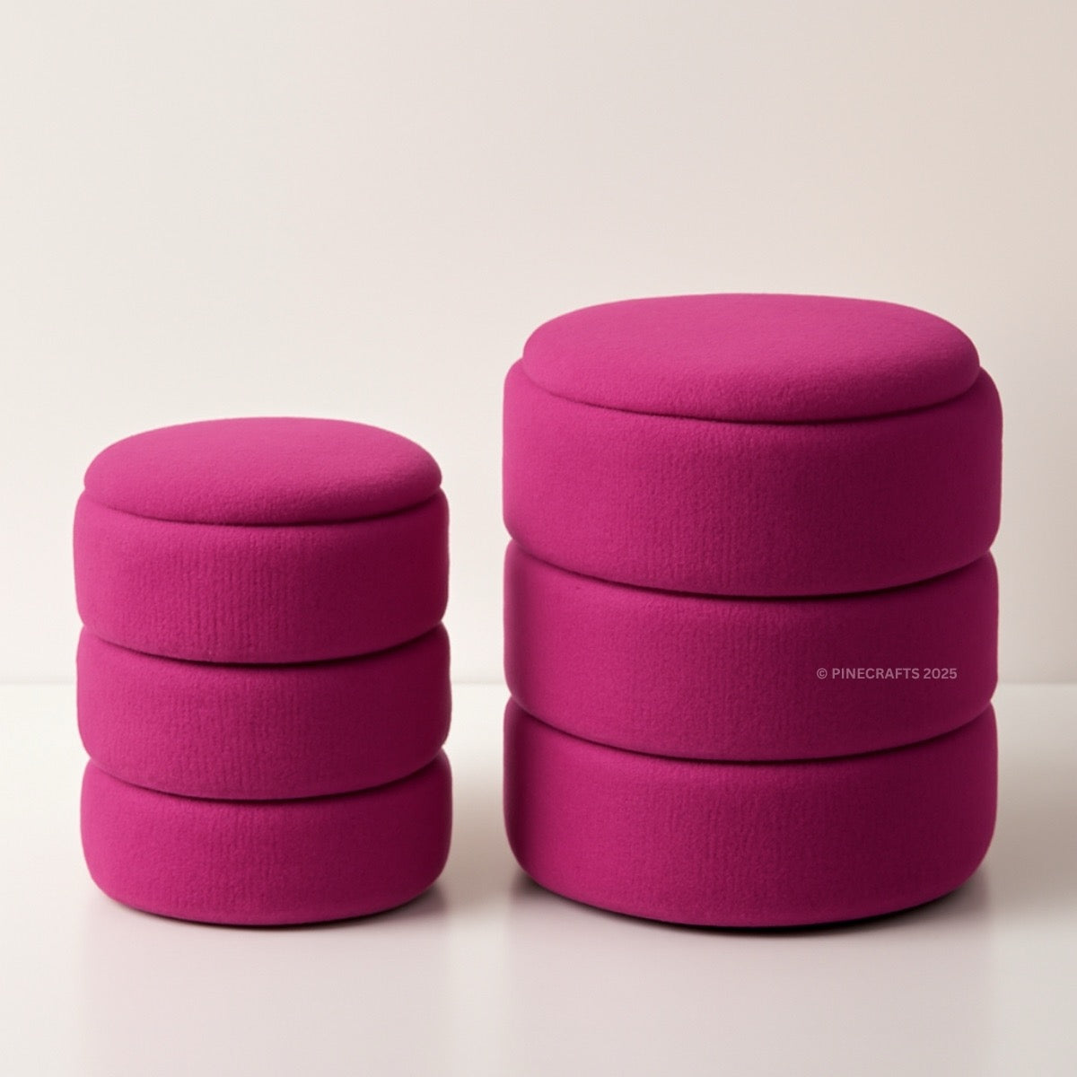 Two pink ottomans stacked on a light beige background