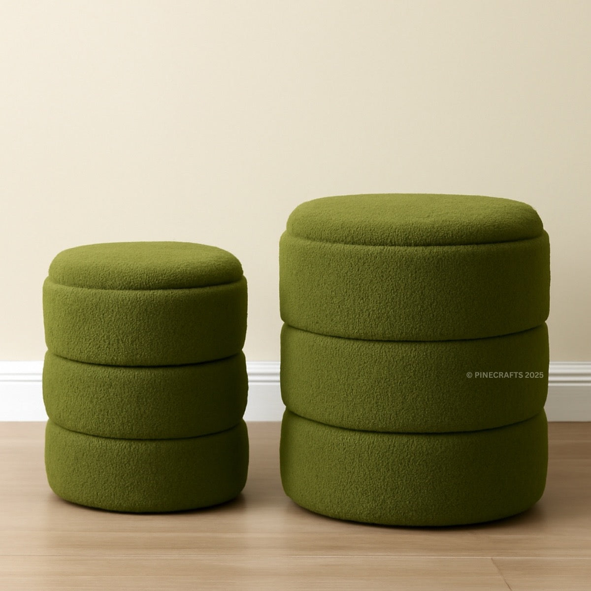 Two green ottomans stacked on top of each other against a beige wall.