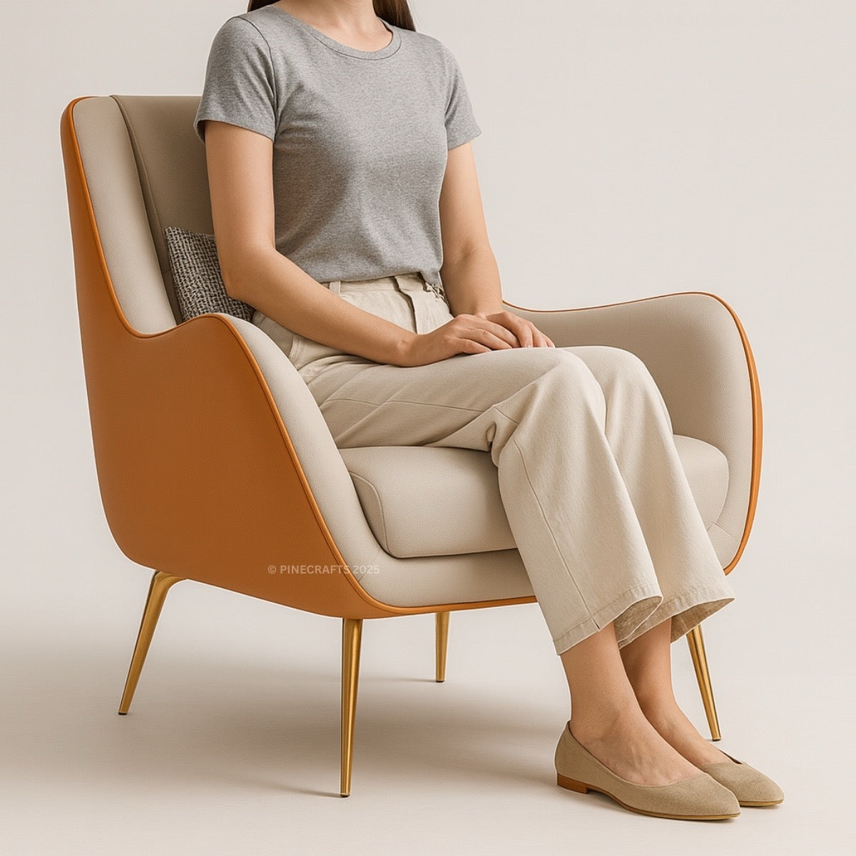 Person sitting on a modern chair wearing a gray shirt and beige pants.