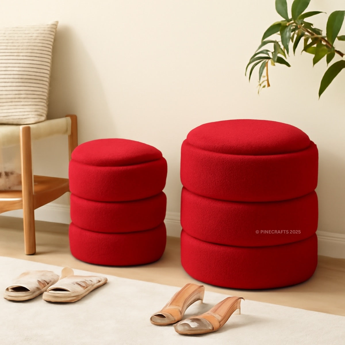 Two red ottomans in a room with a chair, plant, and sandals.