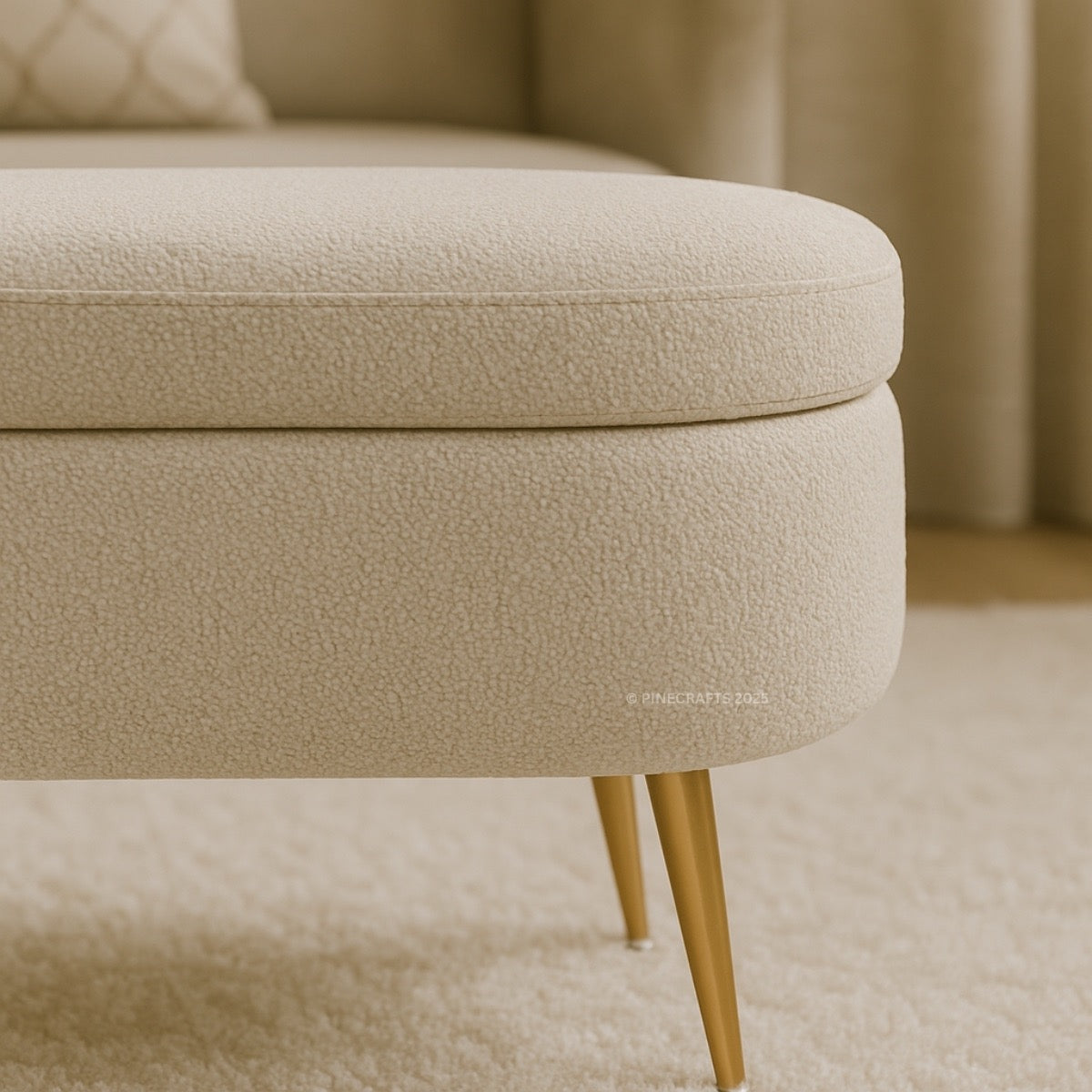 Beige ottoman with gold legs on a neutral background