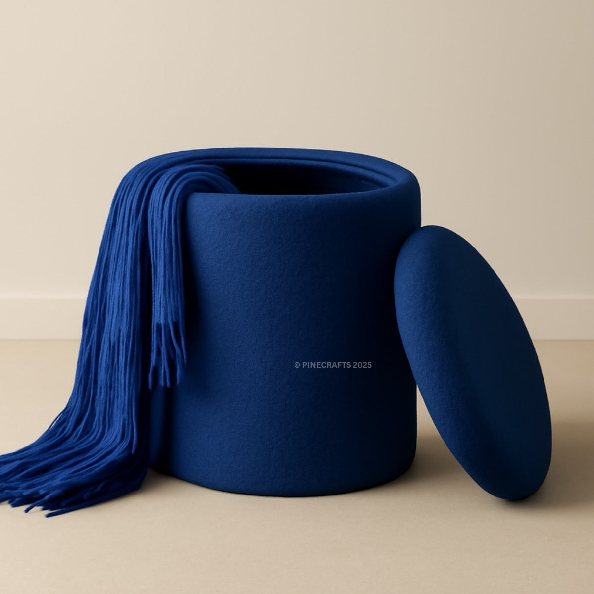 Blue woven basket with a matching blue blanket draped over it on a beige background