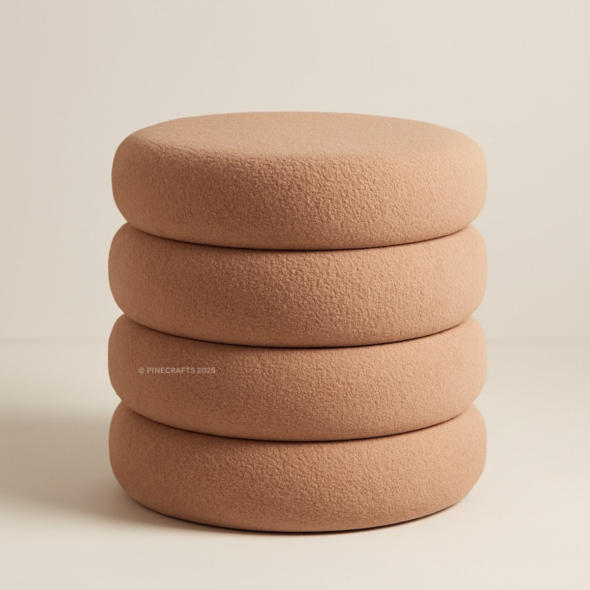 Stack of four brown textured ottomans on a beige background
