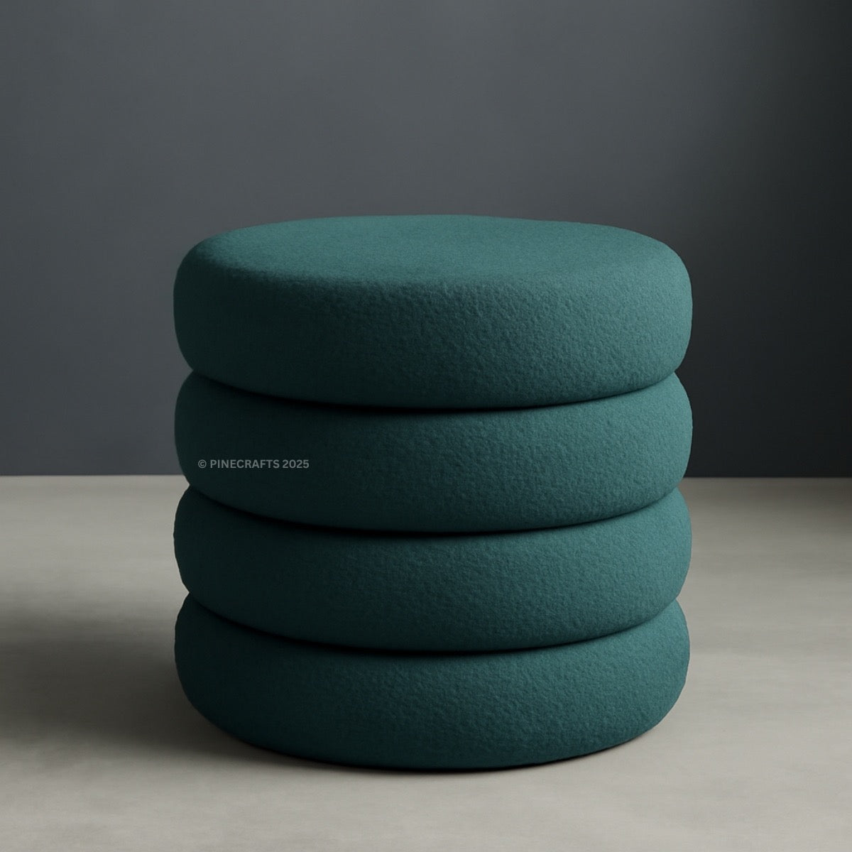 Stack of teal cushions on a neutral background