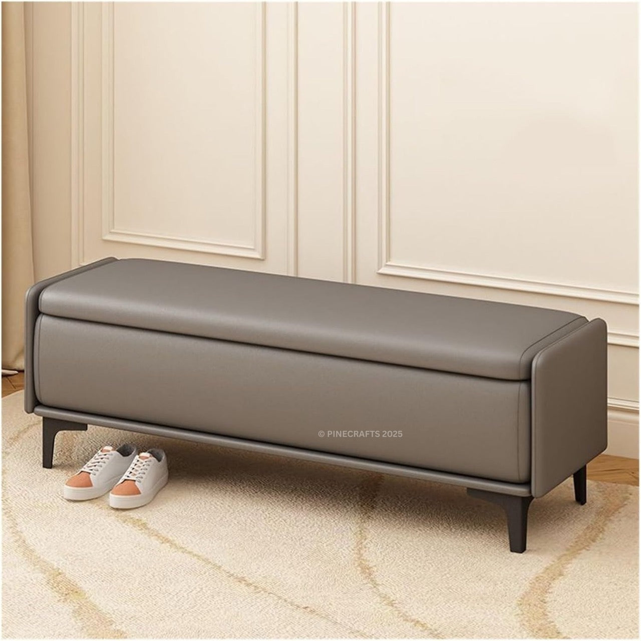 Gray leather bench in a room with beige walls and carpet.