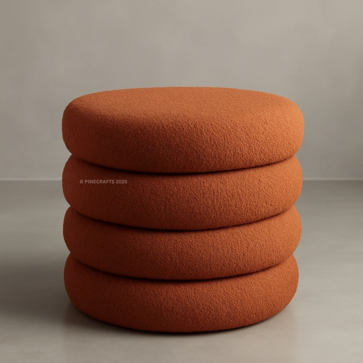 Stack of four orange cushions on a neutral background