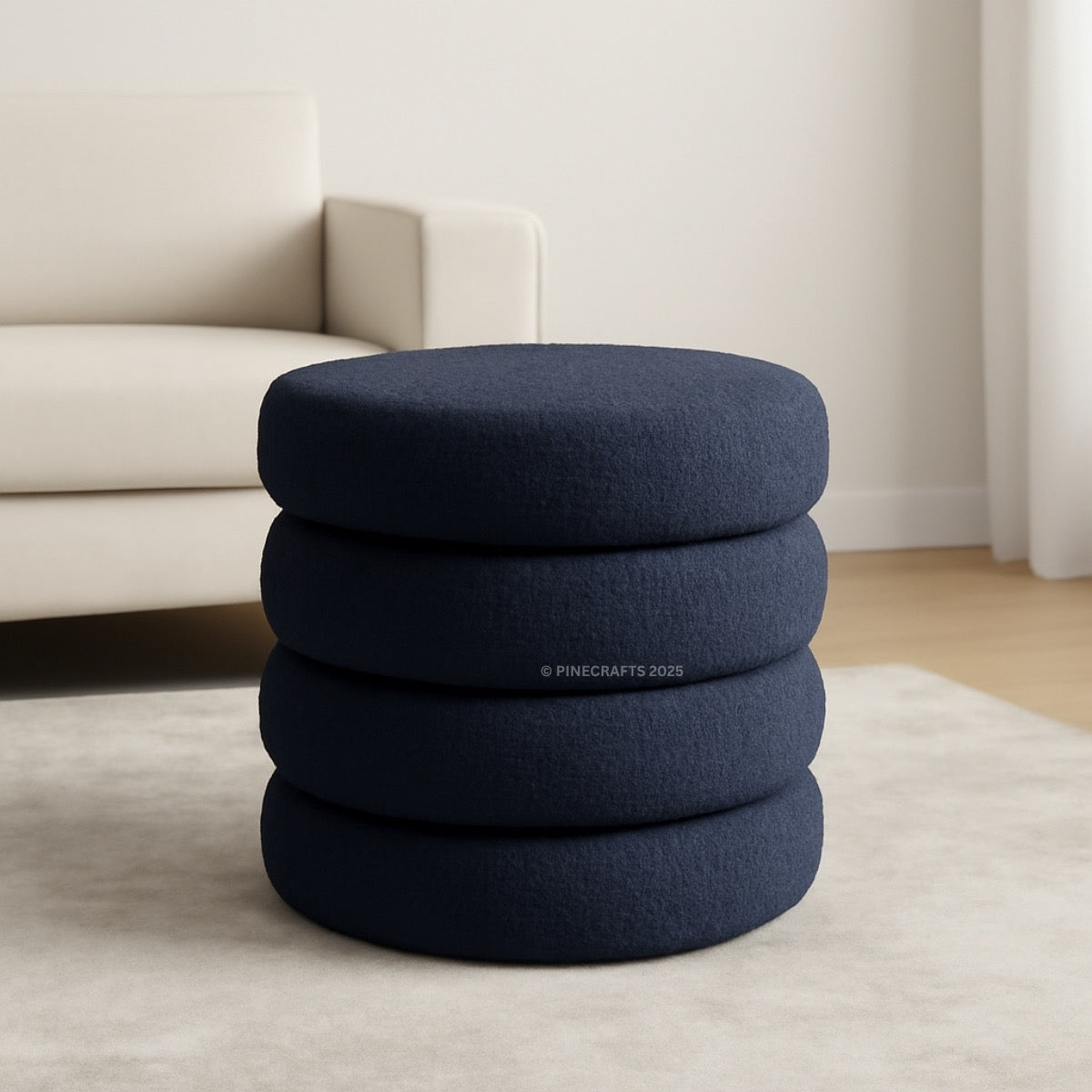Stack of blue cushions on a light-colored floor with a neutral background