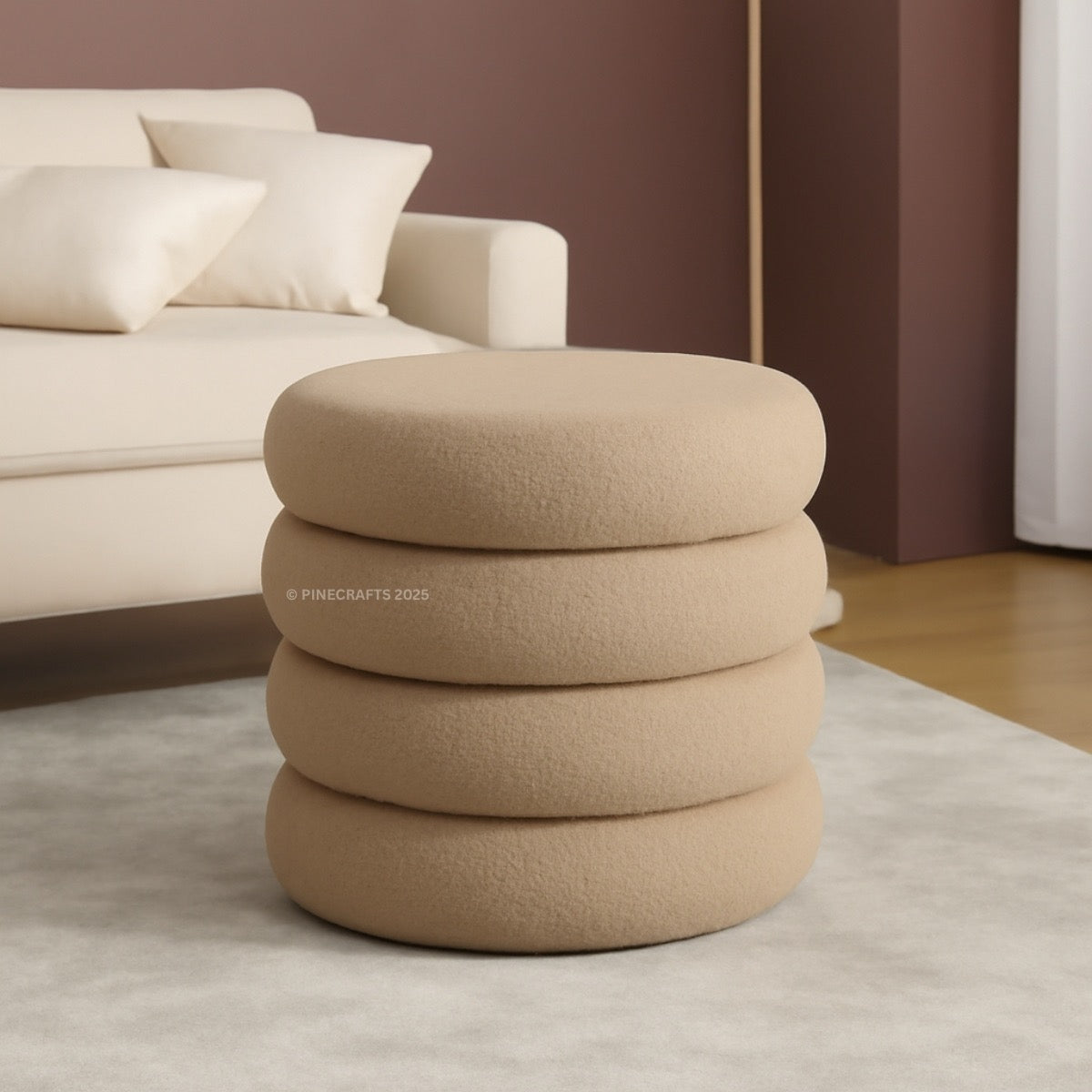 Beige ottoman with stacked circular designs in a living room setting