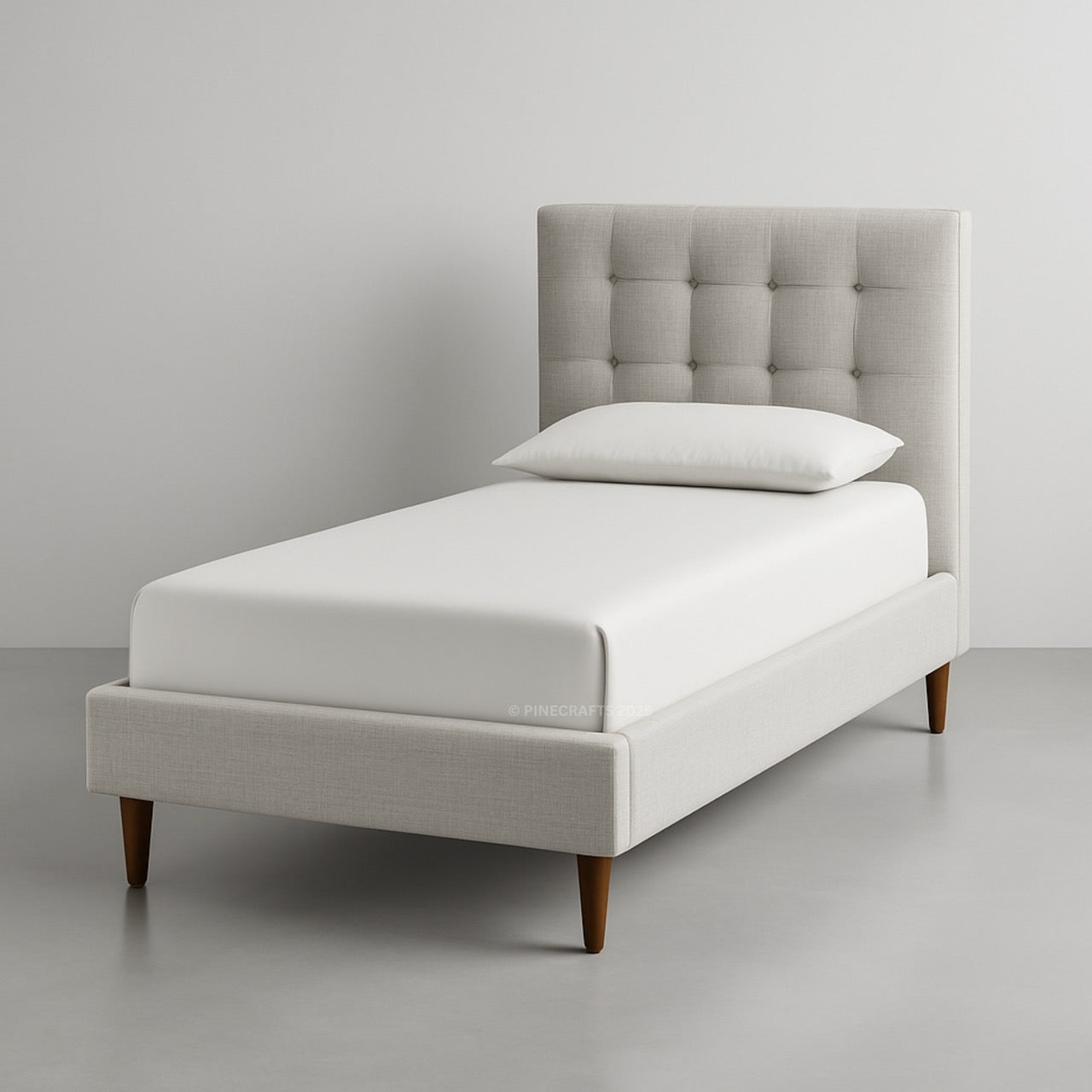 Single bed with tufted headboard and white bedding on a gray background