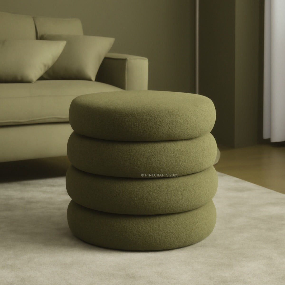 Stack of green ottomans in a room with a sofa and neutral decor.