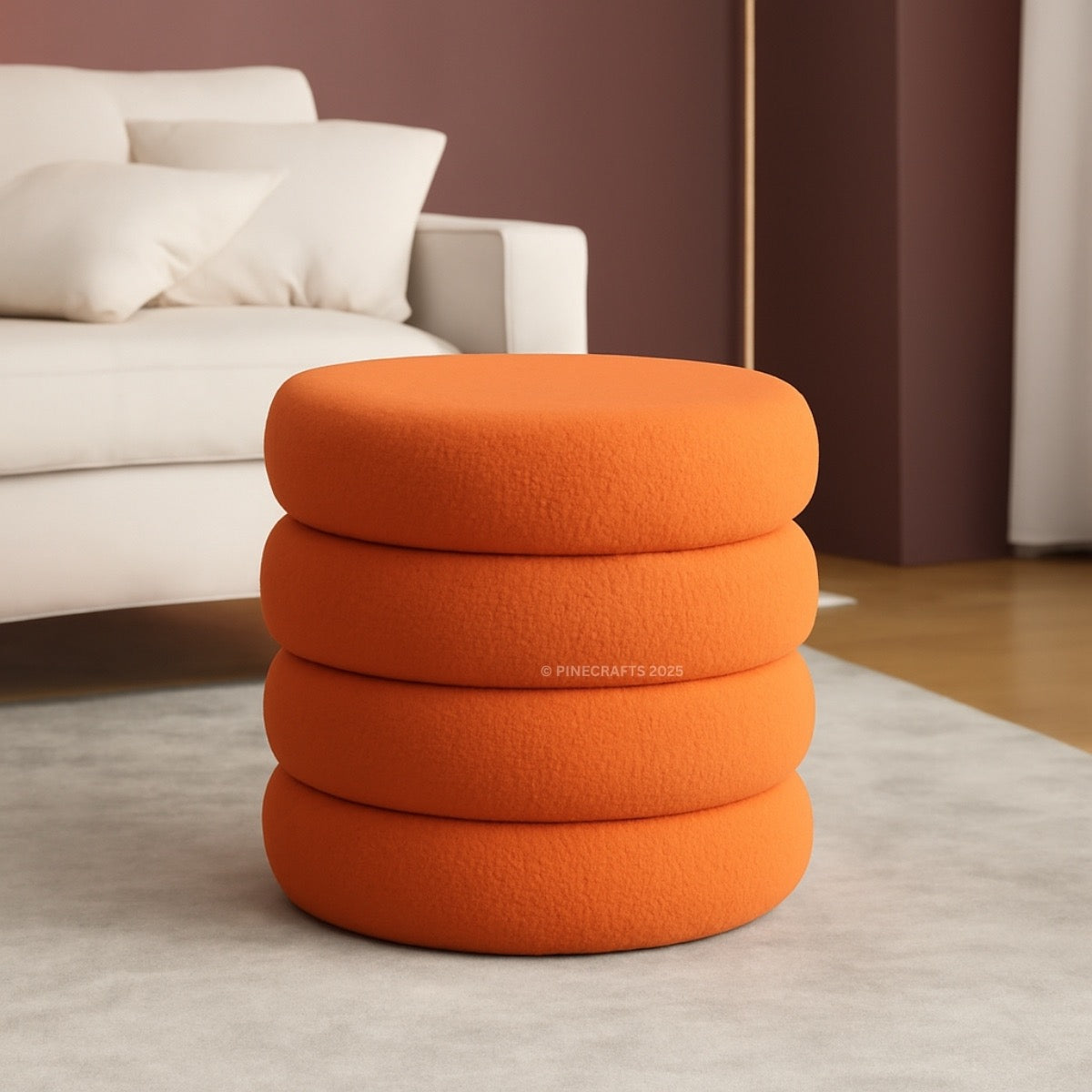 Stack of orange ottomans in a living room setting