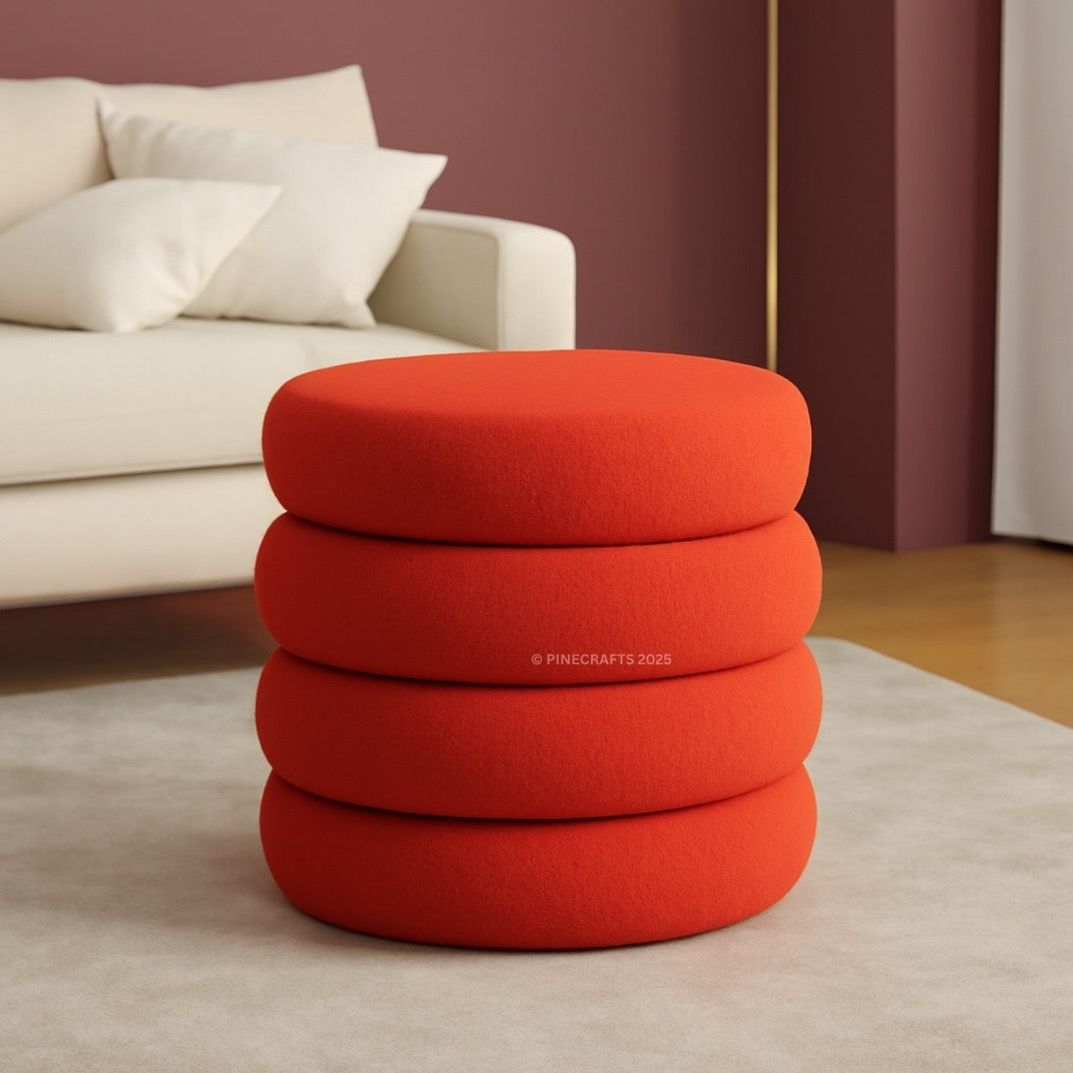 Stack of red ottomans in a living room setting with a beige sofa and white cushions.