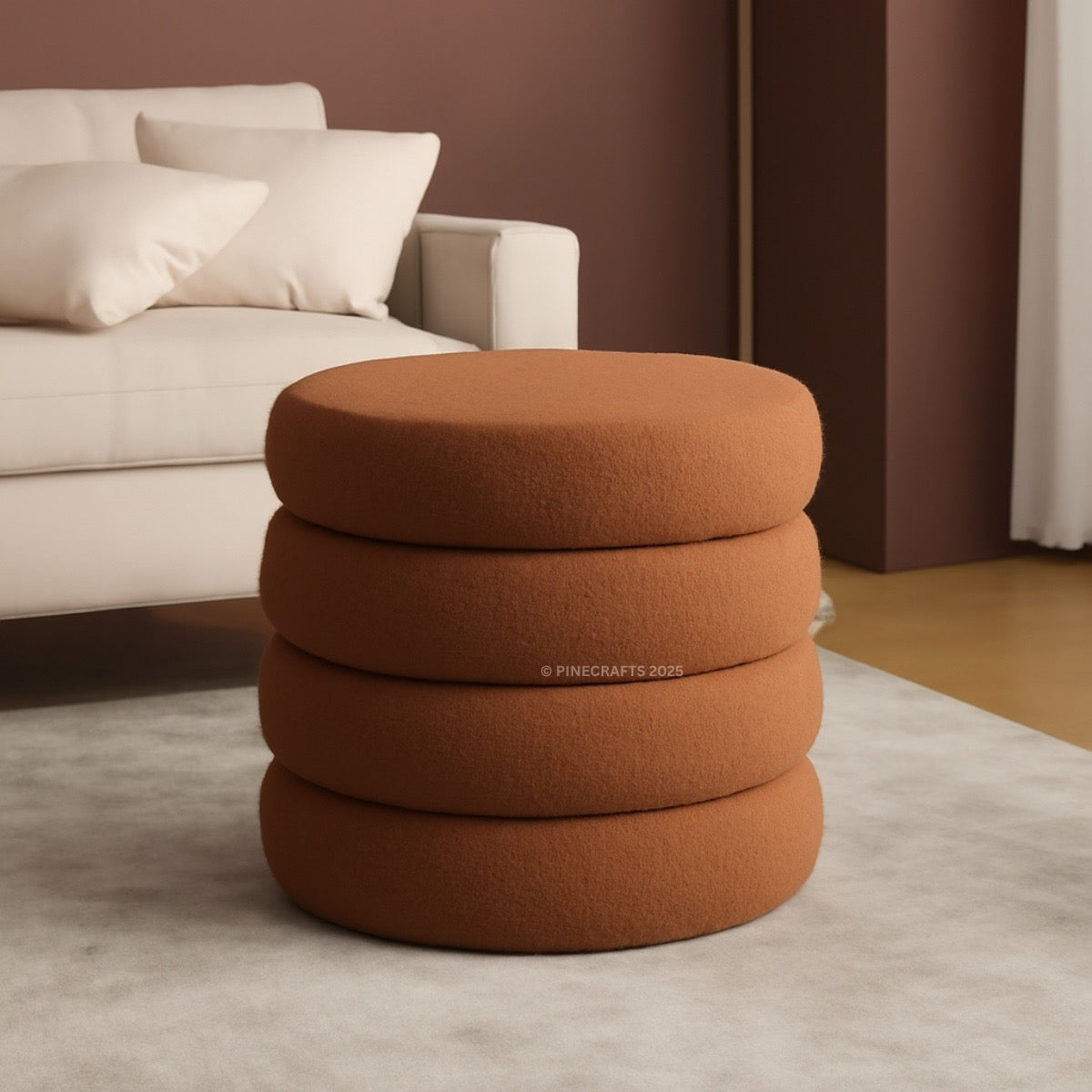 Stack of brown ottomans in a living room setting with a beige sofa and white cushions.