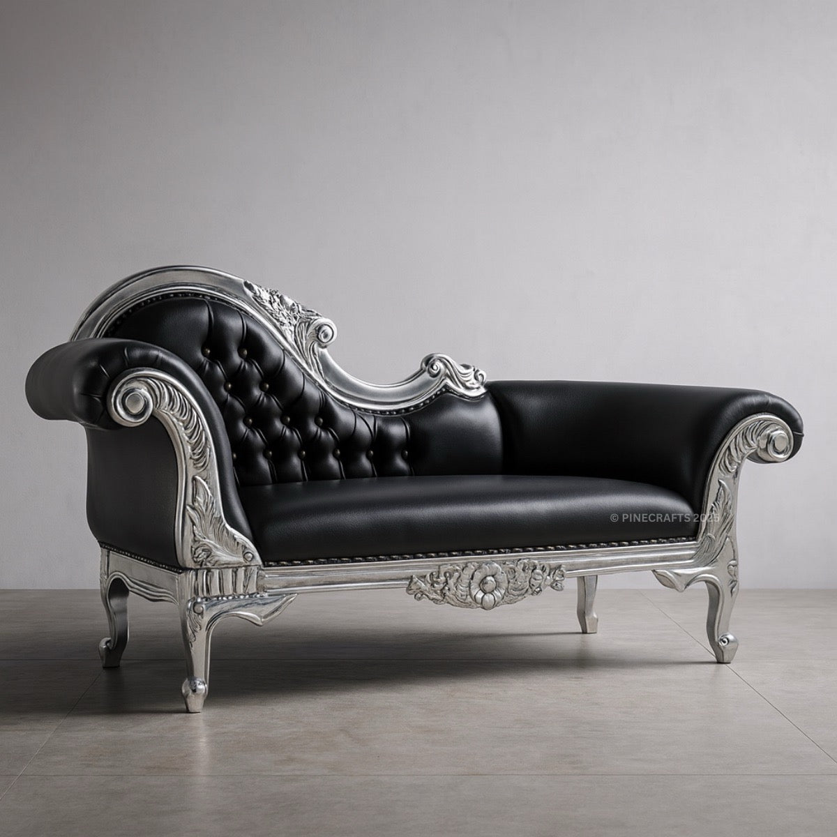 Decorative black sofa with silver embellishments on a gray background