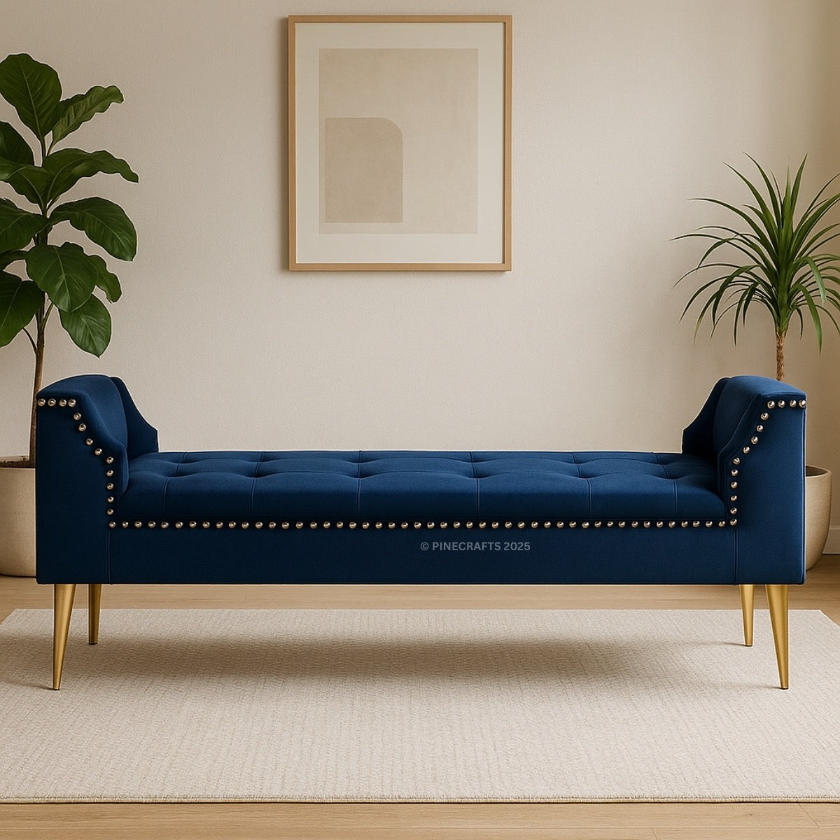 Blue tufted bench with gold legs in a room with plants and a framed picture.