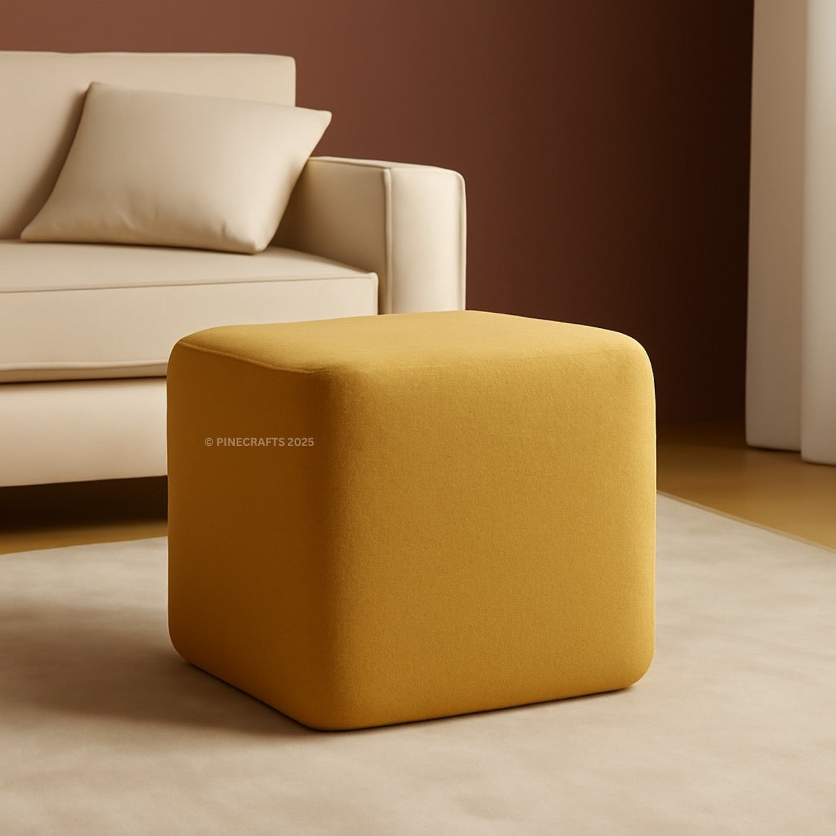 Yellow cube-shaped ottoman in front of a beige sofa against a brown wall.
