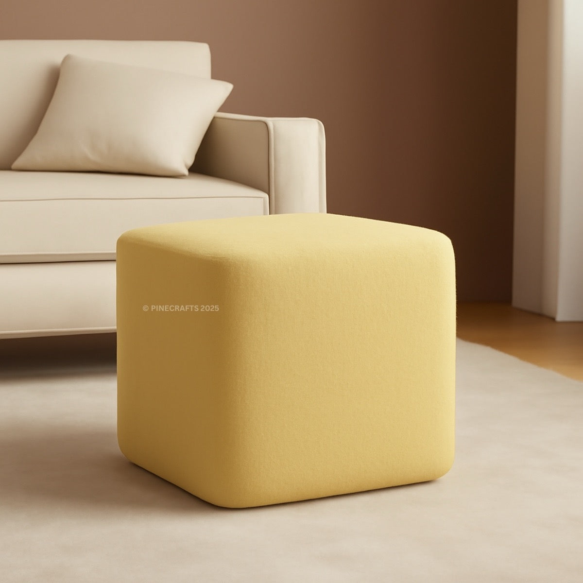 Yellow cube-shaped ottoman in a living room setting with a beige sofa.