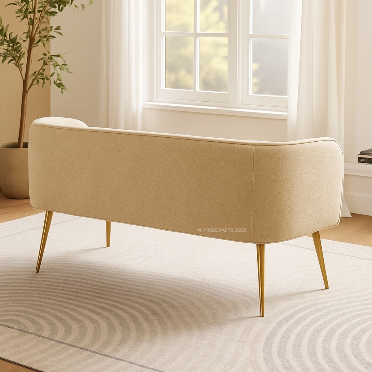 Beige bench with gold legs in a room with a window and plant