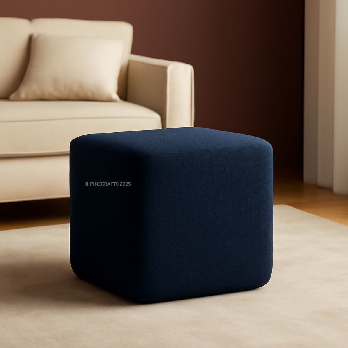 Blue cube-shaped ottoman in a living room setting with beige sofa and carpet.
