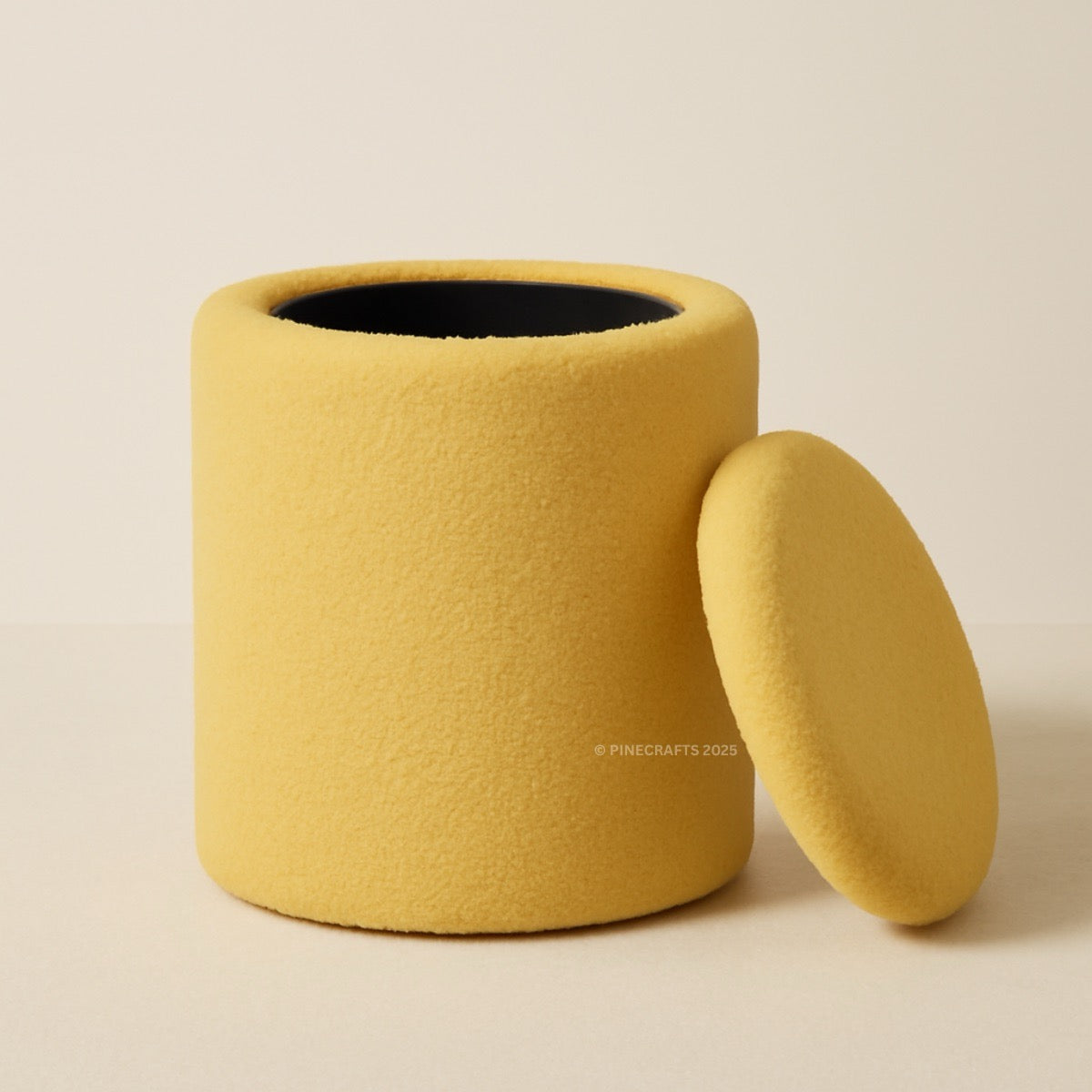 Yellow cylindrical container with a lid on a beige background