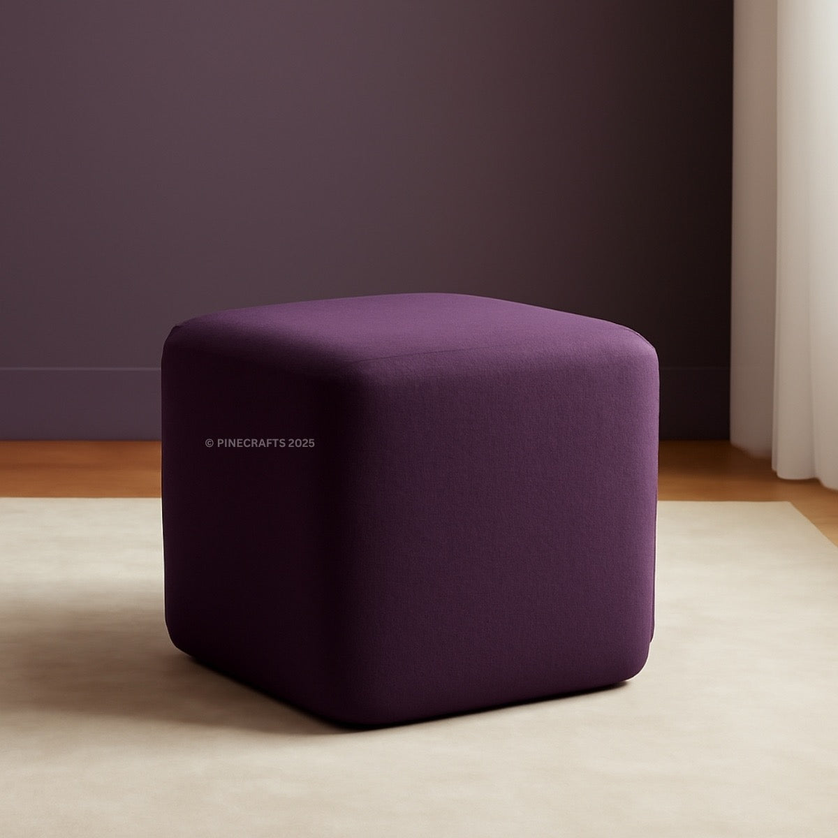 Purple cube-shaped ottoman on a beige rug with a dark purple wall in the background.