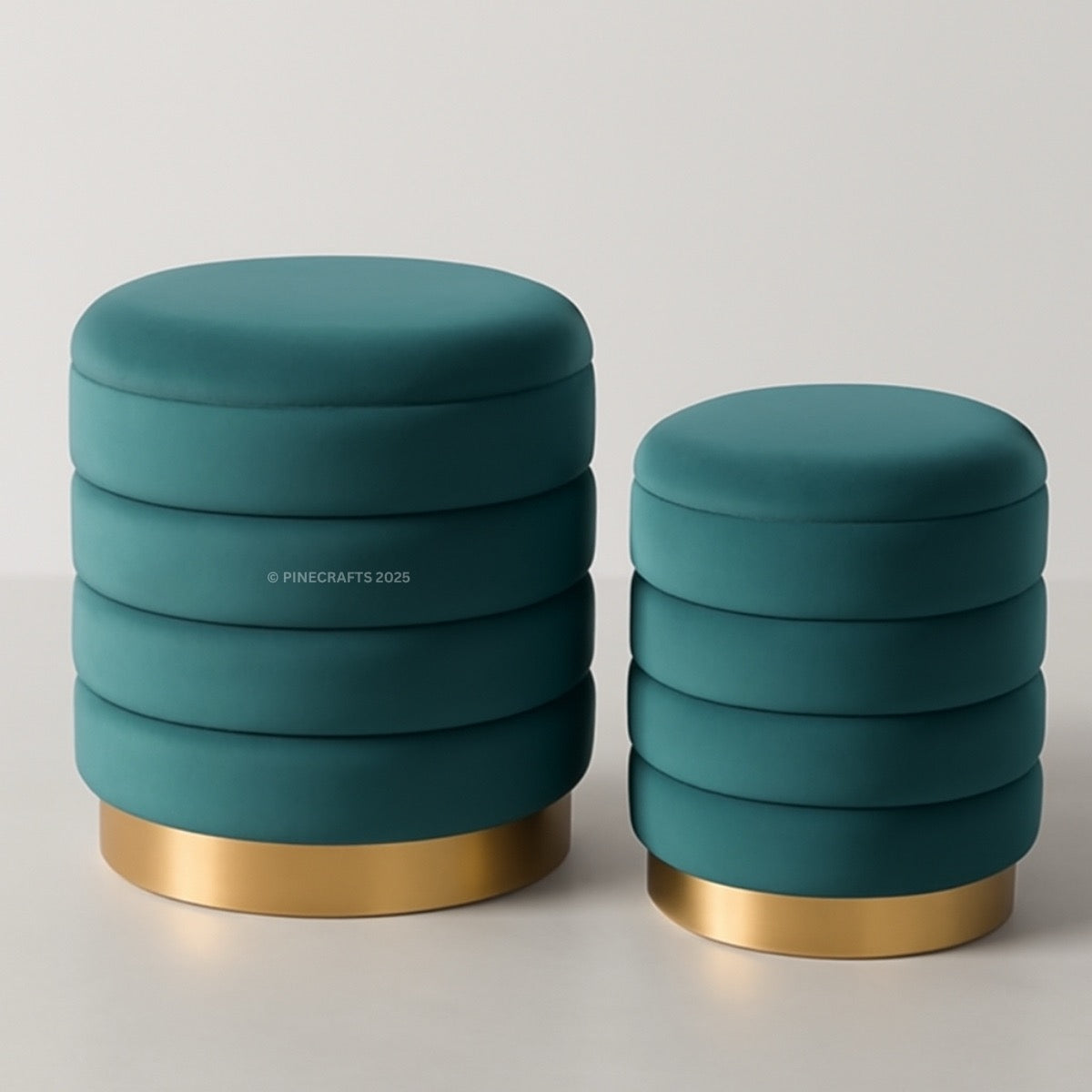Two teal ottomans with gold bases on a light gray background